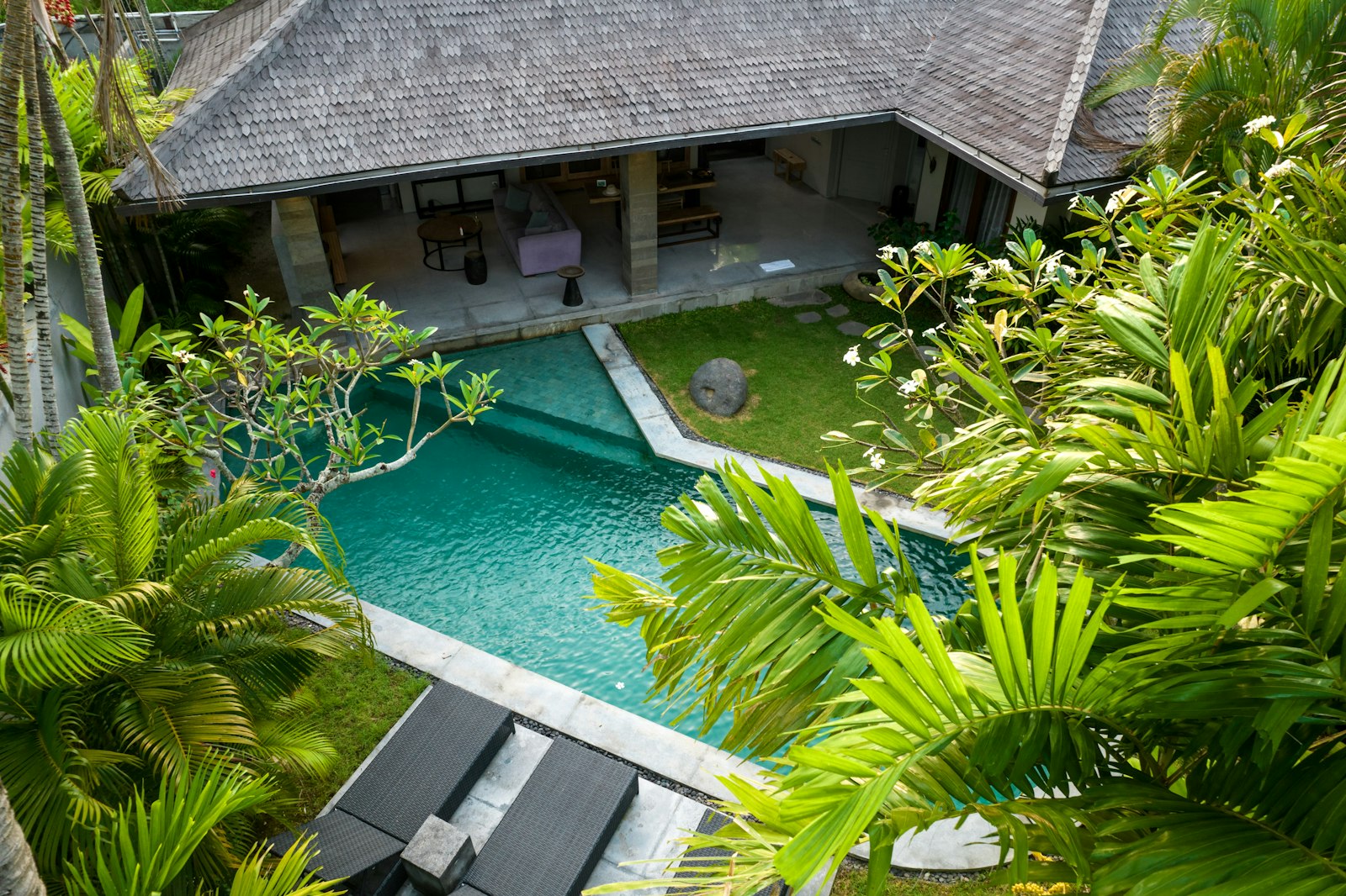 An aerial view of a house with a swimming pool